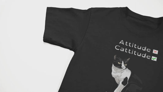 camera pans over a black shirt with a black cat on it and some text